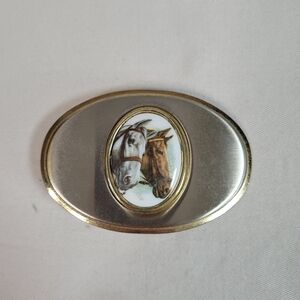 Belt buckle oval shaped two horse head bust brass colored